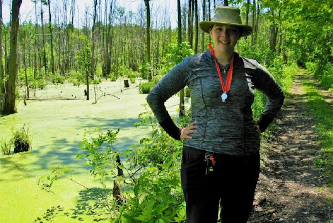 Audréanne Loiselle in one of her fields of research, a treed marsh (Laval, 2017).